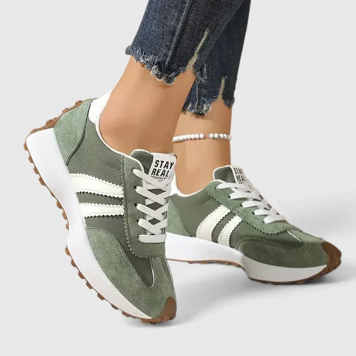 Green comfort sneakers with white side stripes and lace-up front, chunky sole