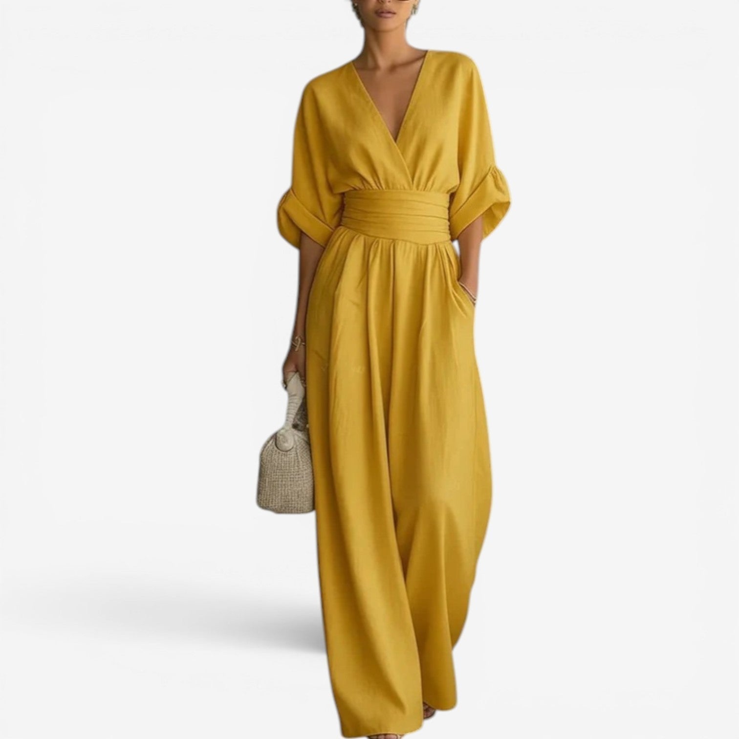 Mustard yellow V-neck jumpsuit with cinched waist and flowing wide legs.