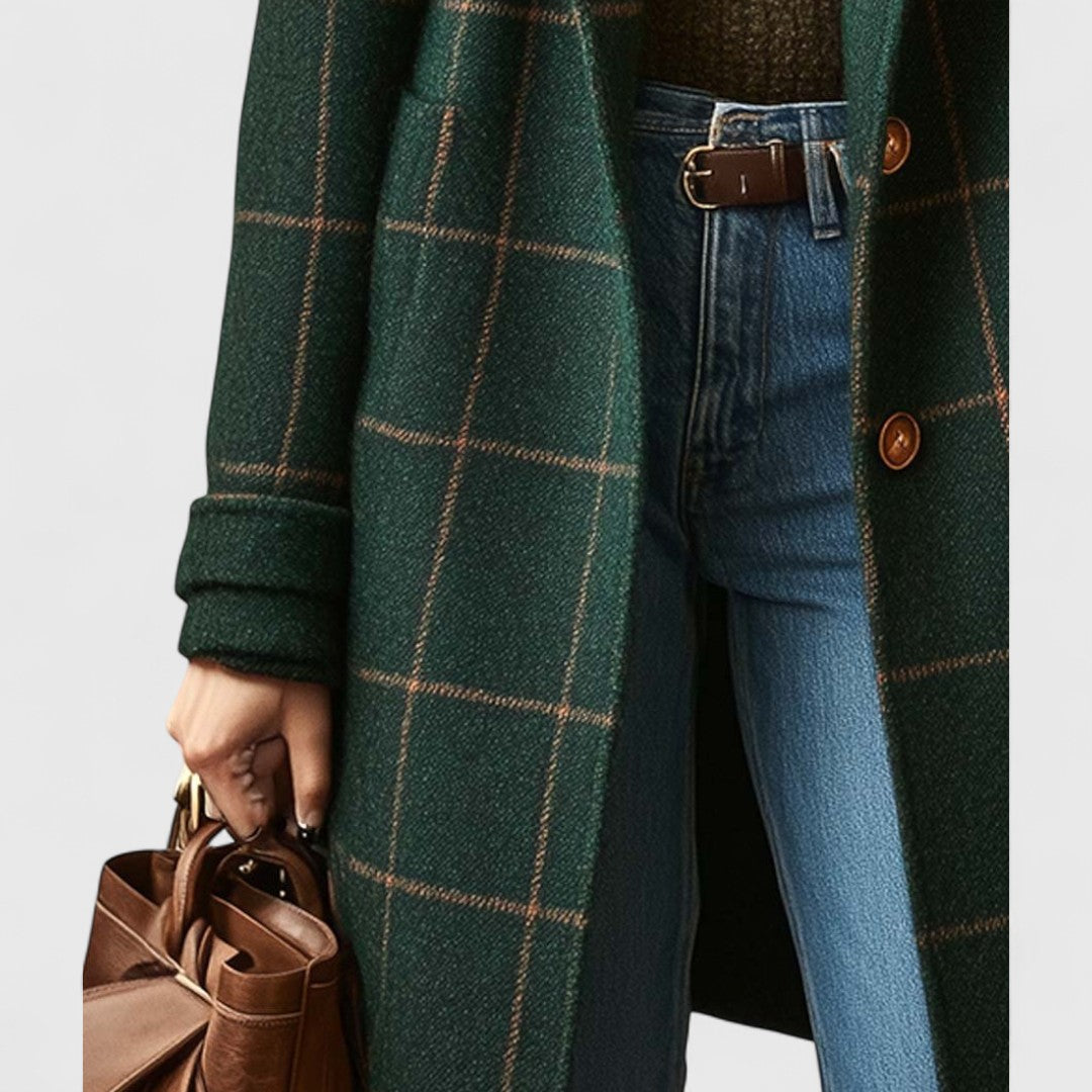 Dark green plaid long coat close-up with brown buttons and cuffed sleeves