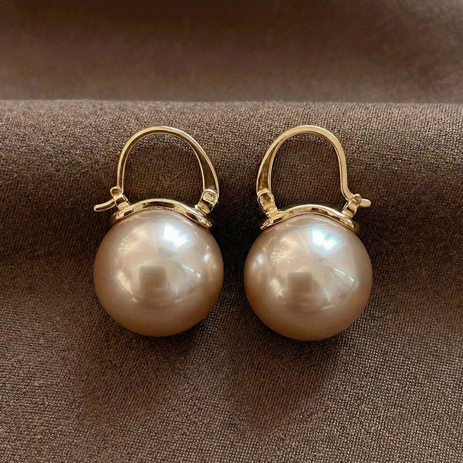 Gold hoop pearl earrings with two large round white pearls, front view