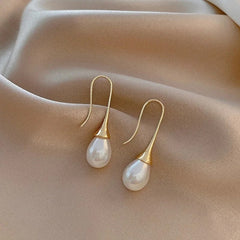 Gold-tone teardrop dangle earrings with white pearl drops