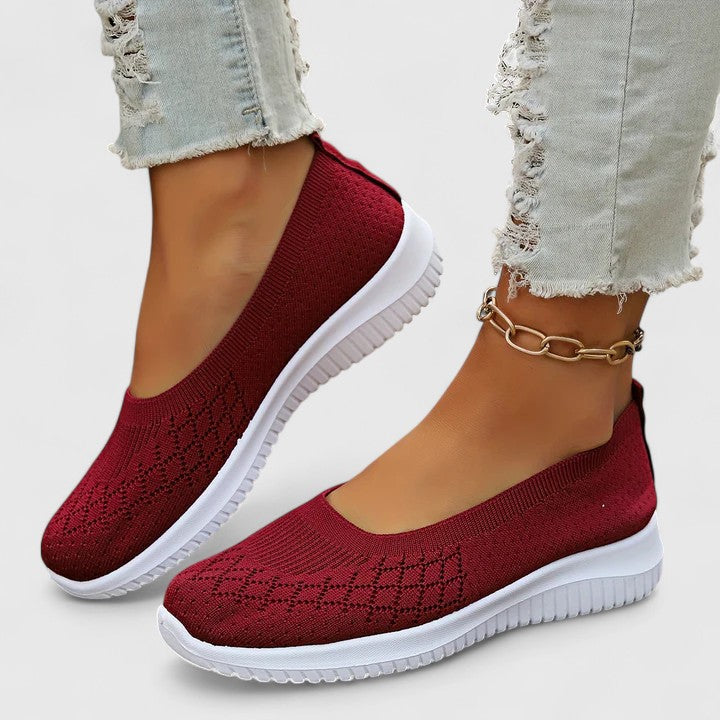 Red knit slip-on sneakers with white sole and ankle chain detail
