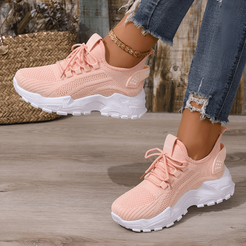 Pink comfort sneakers with knitted upper, lace-up closure and white outsole