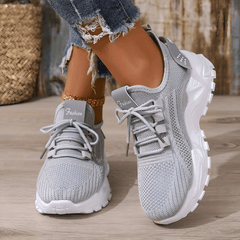 Grey knit comfort sneakers with lace-up front and textured white tread sole