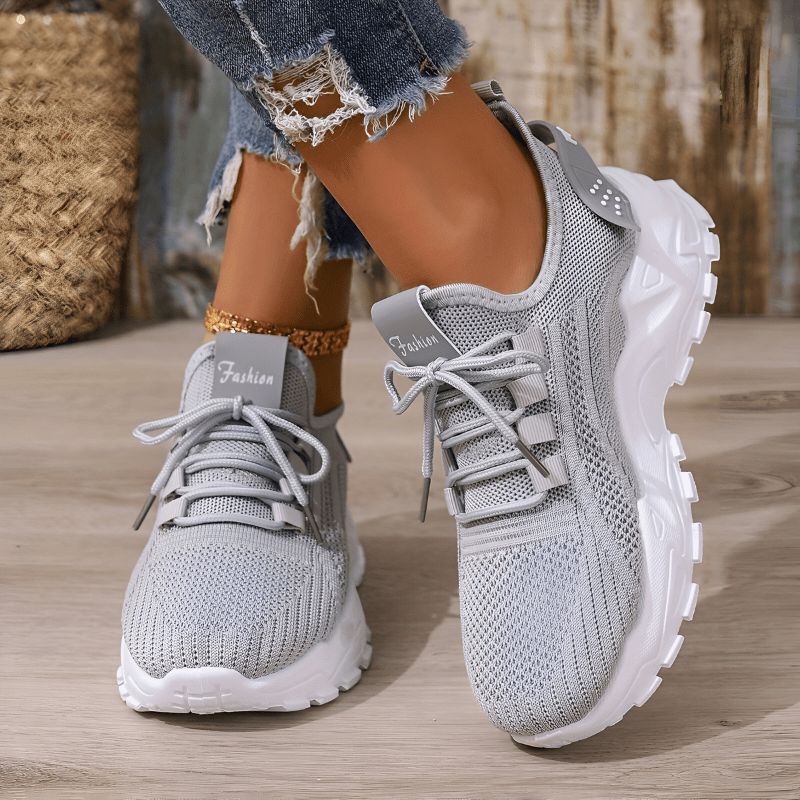 Grey knit comfort sneakers with lace-up front and textured white tread sole