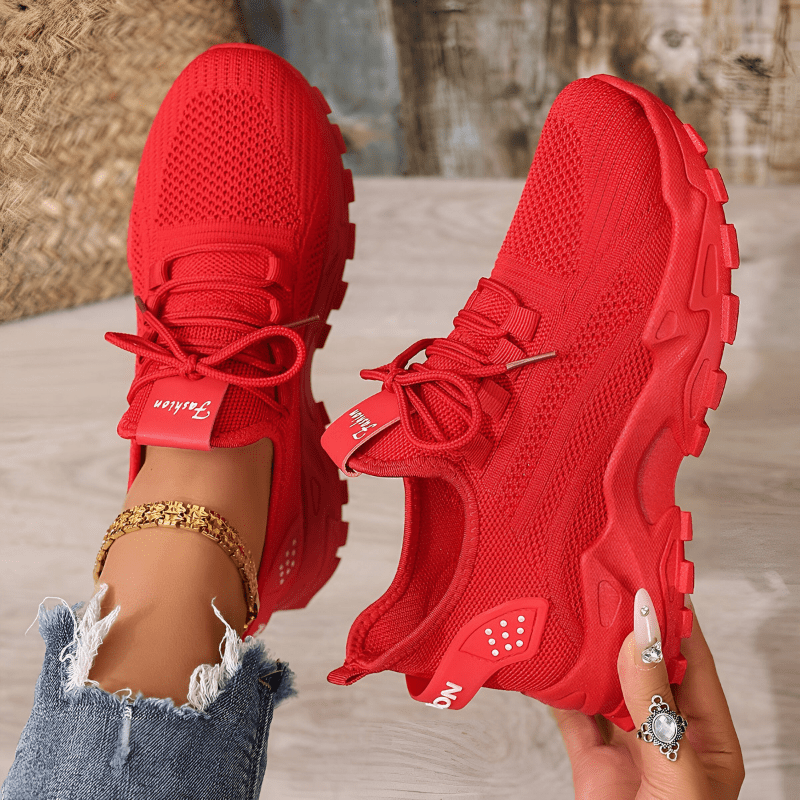 Red comfort sneakers with knitted upper, lace-up front and rugged outsole