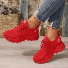 Red lace-up sneakers with breathable knit upper and chunky tread sole
