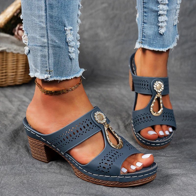 Navy perforated slide sandals with decorative charm strap and chunky block heel