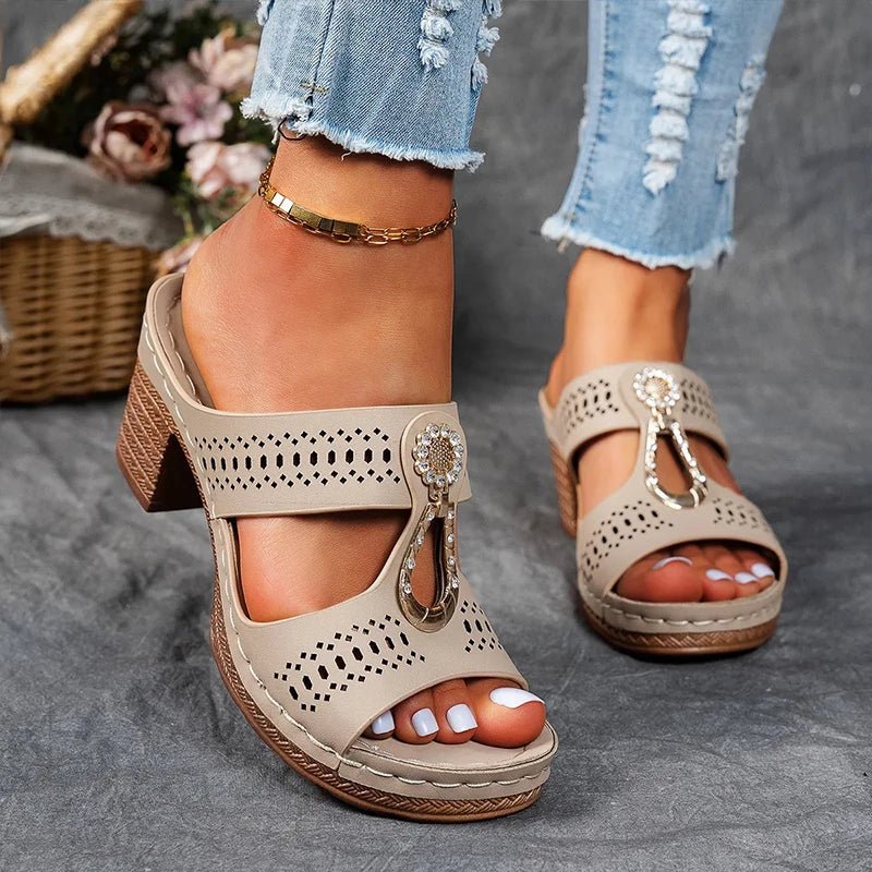 Beige perforated slide sandals with rhinestone charm and chunky block heel