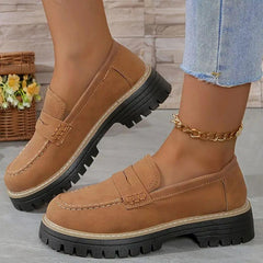 Brown comfort loafers with slip-on strap detail and thick lug tread sole