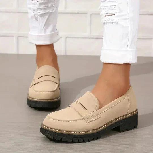 Beige comfort loafers with buckle strap and thick tread platform sole