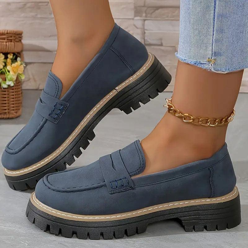 Blue comfort loafers with buckle strap detail and chunky tread sole