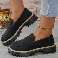 Black comfort loafers with slip-on vamp strap and rugged tread sole