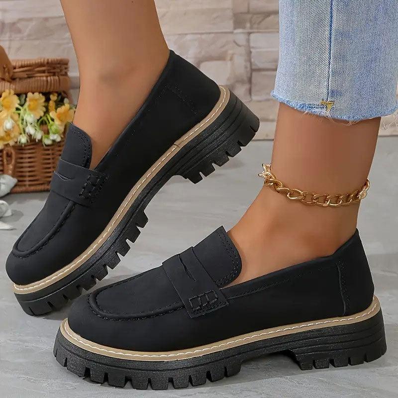 Black comfort loafers with slip-on vamp strap and rugged tread sole