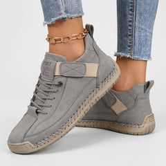 Grey comfort sneakers with lace-up front, ankle strap, and contrast heel tab
