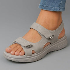 Grey open-toe sandals with two hook-and-loop straps and thick cushioned sole