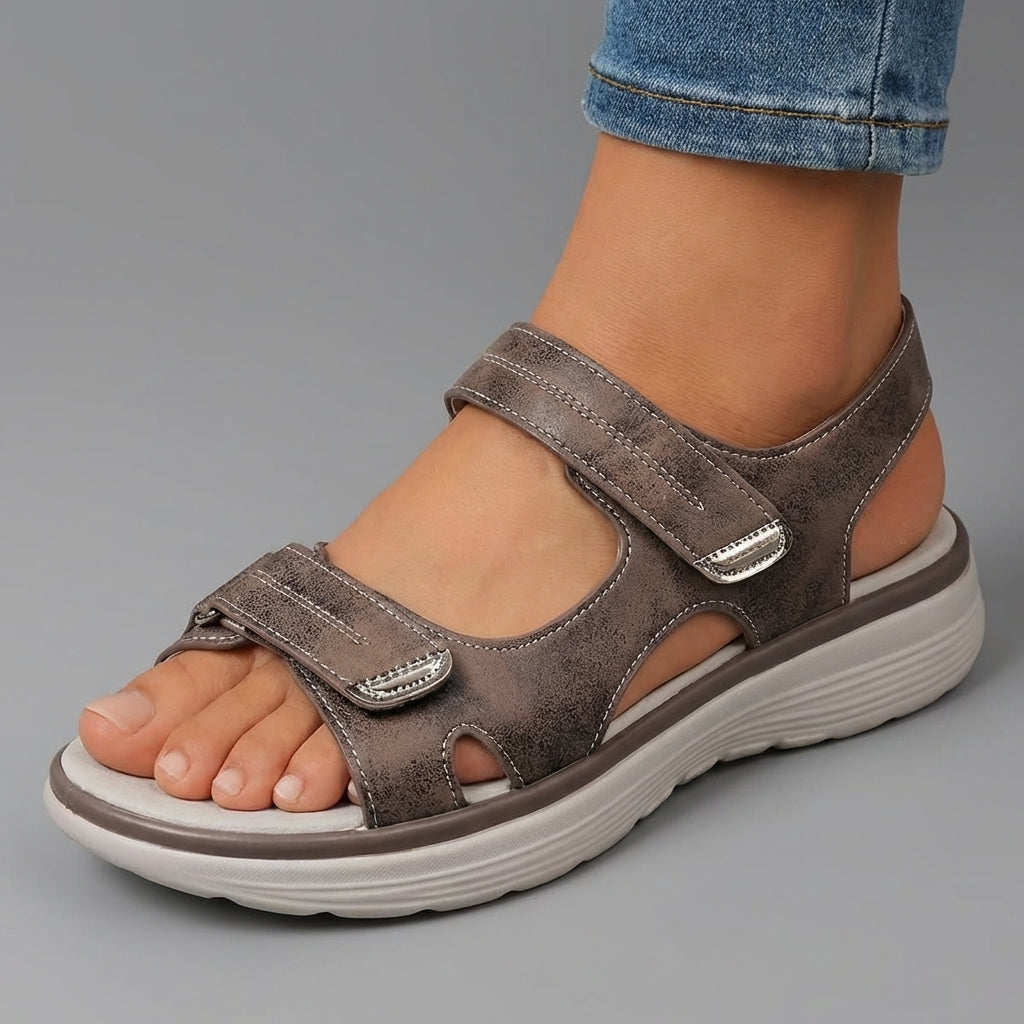 Brown open-toe sandals with two hook-and-loop straps and thick cushioned sole