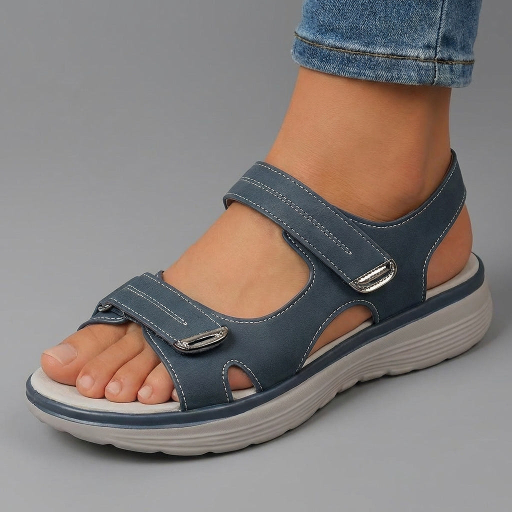 Blue open-toe sandals with two hook-and-loop straps and contoured cushioned sole