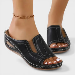 Black open-toe slip-on sandals with side panels and stitched platform sole