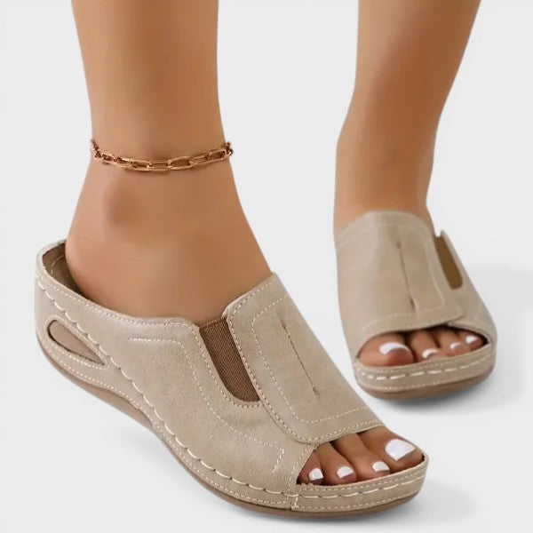 Beige open-toe slip-on sandals with cushioned footbed and stitched trim