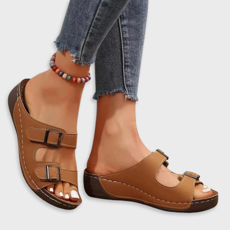 Brown sandals with two adjustable buckle straps and open-toe wedge sole