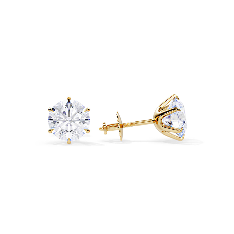 Gold-tone earrings with round clear crystal studs and gold back posts