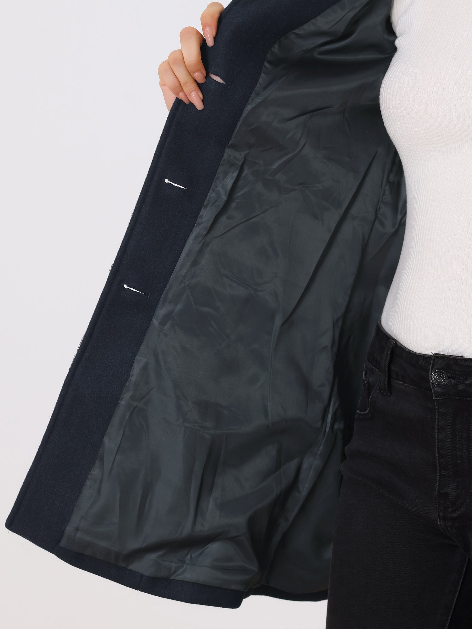 Navy trench coat with black satin lining and side button detail.